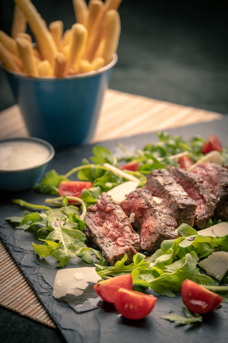 Sliced steak salad with fries