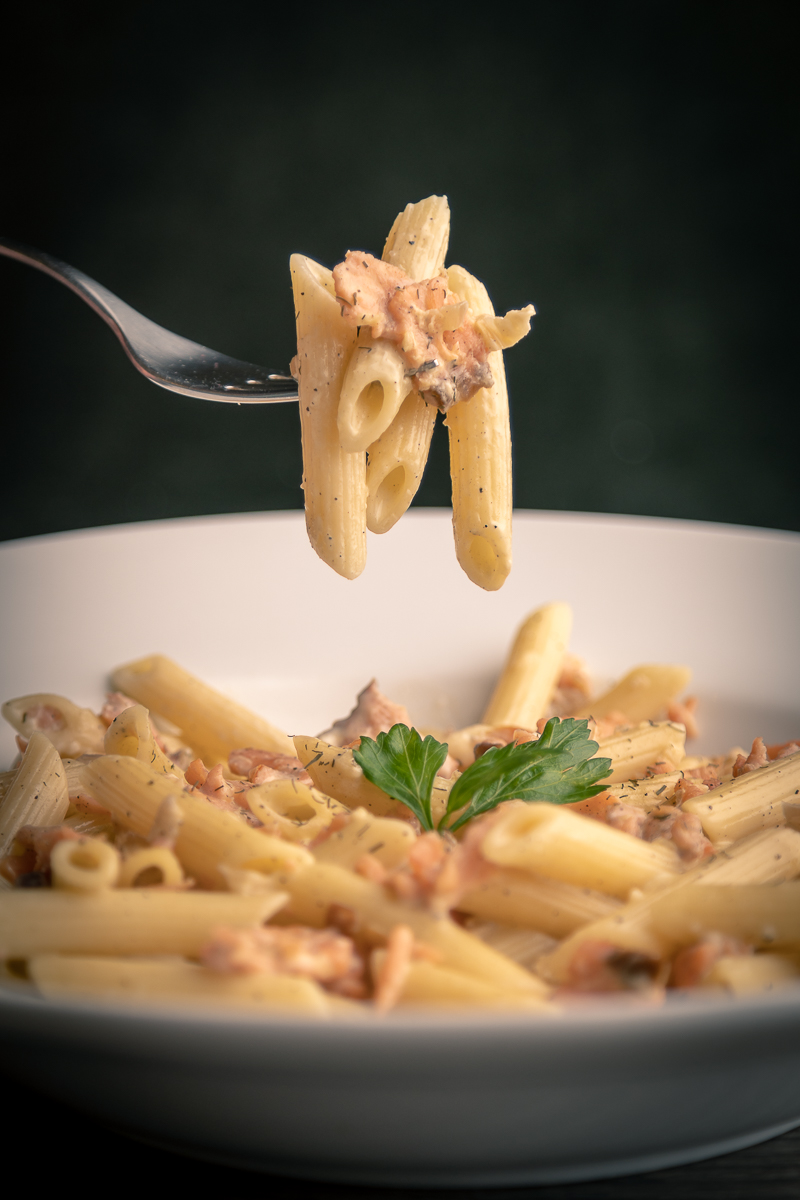 Creamy penne pasta on a fork