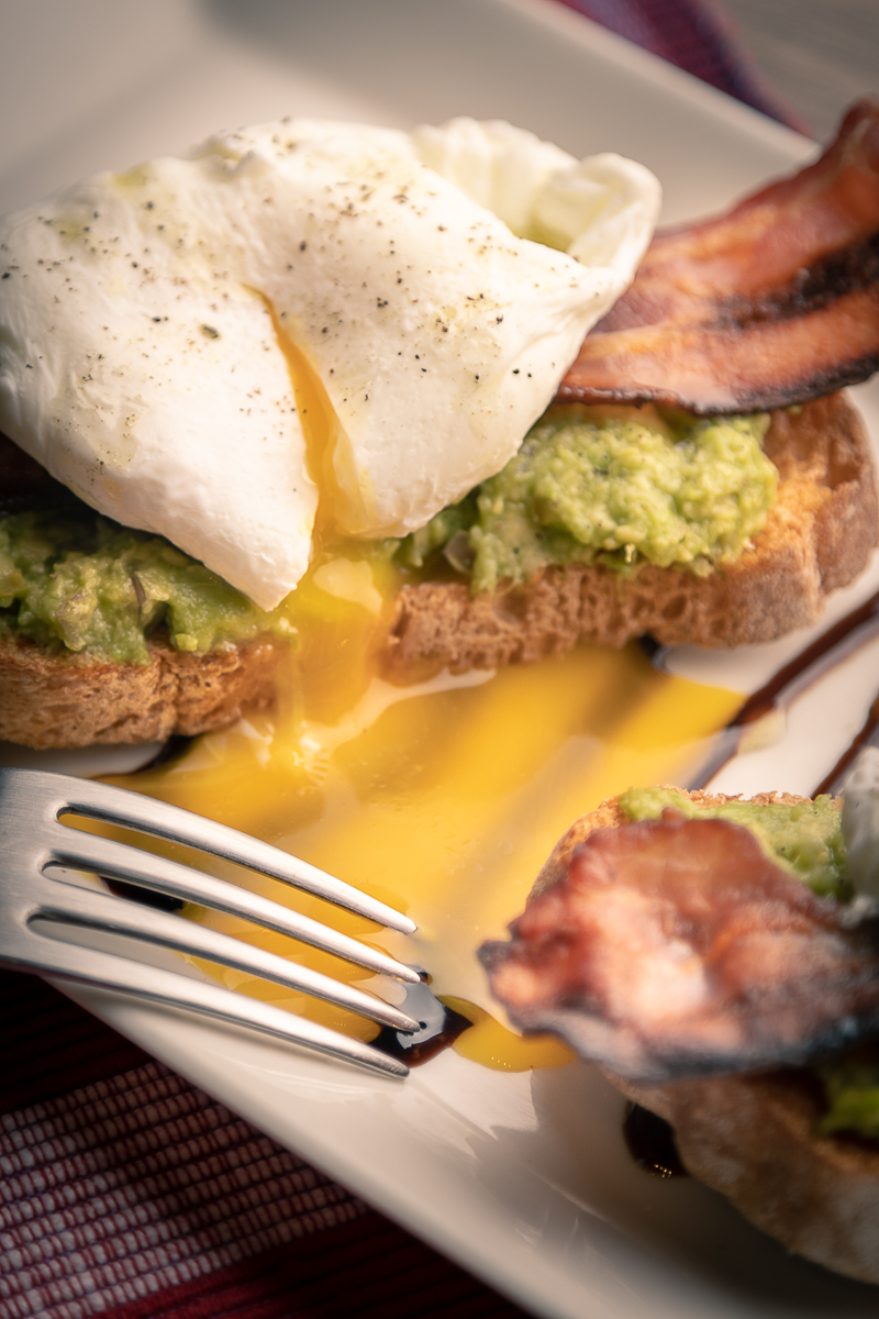 Avocado toast with poached egg and bacon